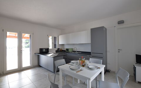 Villa Del Sole In Budoni Sea View: Furniture, Building, Table, Cabinetry, Kitchen, Countertop, Chair, Flooring, Wood