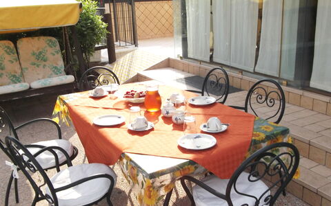 Villa Paradiso: Table, Furniture, Bicycle, Property, Tableware, Chair, Outdoor Table, Wood, Outdoor Furniture, Plant