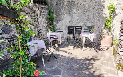 Gravedona 786: Plant, Property, Table, Chair, Outdoor Table, Road Surface, Flower, Outdoor Furniture, Grass, Landscape