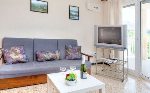 El Port de la Selva 101: Table, Furniture, Property, Couch, Green, Comfort, Picture Frame, Living Room, Interior Design, Lighting