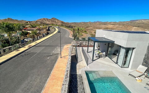 Yucas 1: Sky, Plant, Road Surface, Mountain, Asphalt, Slope, Tree, Residential Area, Urban Design, Landscape