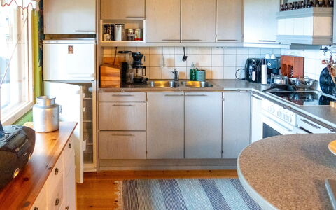 Villa Wirtanen: Kitchen Appliance, Kitchen, Countertop, Major Appliance, Cabinetry, Interior Design, Flooring, Furniture, Kitchen Sink, Wood