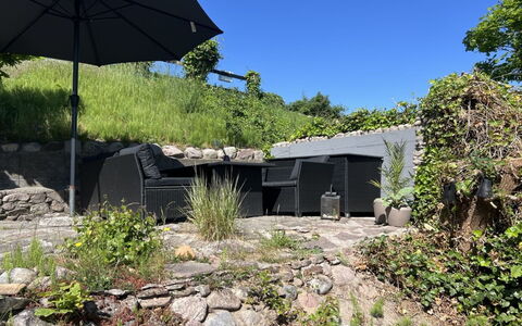 Silke - 10M from the Sea: Shrub, Garden, Outdoor Furniture, Shade, Landscaping, Umbrella, Backyard, Chair, Concrete