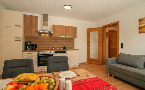 Ferienwohnung Selina: Furniture, Cabinetry, Food, Tableware, Countertop, Orange, Wood, Table, Interior Design