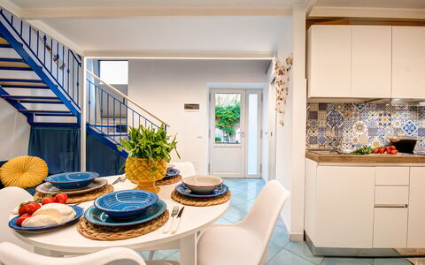 Casetta Di Laura In Massa Lubrense: Table, Furniture, Cabinetry, Azure, Dishware, Floor, Plant, Houseplant, Flooring, Living Room