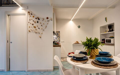 Casetta Di Laura In Massa Lubrense: Plant, Table, Chair, Lighting, Houseplant, Flowerpot, Interior Design, Flooring, Floor