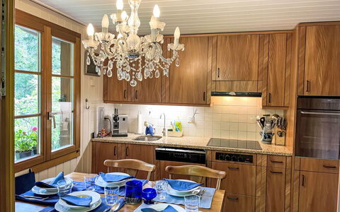 Chalet Tannengüetli: Property, Cabinetry, Countertop, Wood, Table, Lighting, Window, Interior Design, Kitchen, Dishware