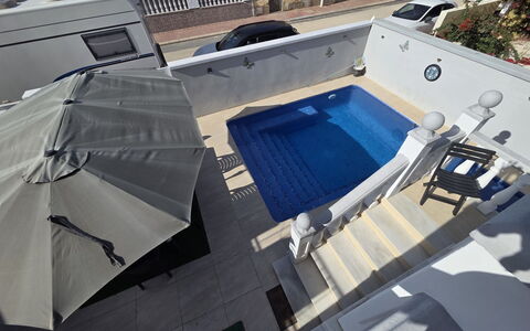Hamber: Swimming Pool, Floor, Flooring, Outdoor Furniture, Composite Material, Umbrella, Courtyard, Leisure, Shade, Chair