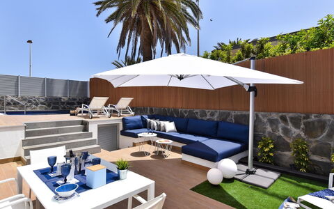 Blue Ocean: Table, Furniture, Sky, Couch, Outdoor Furniture, Swimming Pool, Shade, Plant, Tree, Umbrella