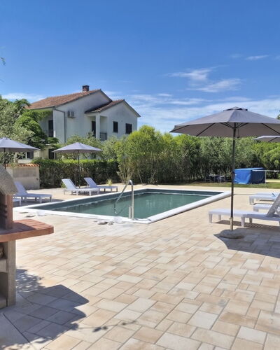 Aria: Outdoor Furniture, Furniture, Flagstone, Shade, Composite Material, Chair, Swimming Pool, Umbrella, Tile, Garden