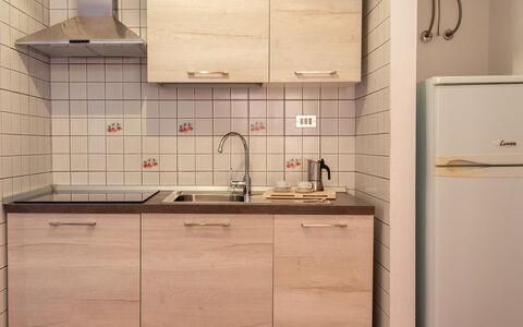 Casa Pavoncelle Apartments In Gallura: Kitchen, Countertop, Kitchen Sink, Kitchen Appliance, Cabinetry, Sink, Major Appliance, Plumbing Fixture, Wood, Flooring