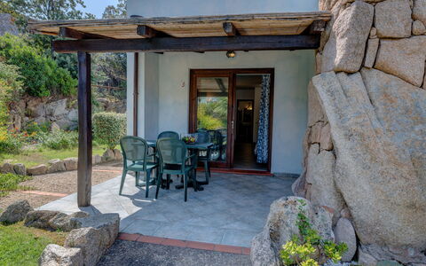 Casa Faro Green Village Sardegna: Plant, Property, Building, Door, Window, Chair, Shade, House, Tree, Porch