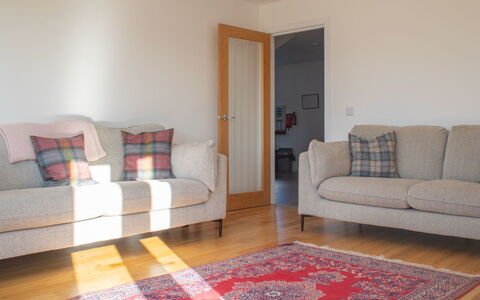 Carbost Cottage: Couch, Flooring, Floor, Interior Design, Wood, Furniture, Living Room, Room