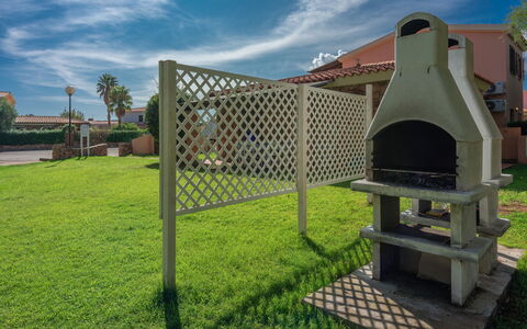 San Teodoro Apartments: Garden, Lawn, Shade, Backyard, Yard, Landscaping, Artificial Turf, Outdoor Structure, Courtyard, Park