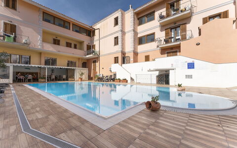 Cristal Blu Apartments In Santa Teresa Gallura: Swimming Pool, Resort, Residential Area, Apartment, Human Settlement, Thermae, Hotel, Umbrella, Leisure Centre, Balcony
