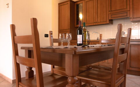 Violet Residence In Orosei: Furniture, Wood, Flooring, Table, Kitchen & Dining Room Table, Interior Design, Brown, Floor, Dining Room, Chair
