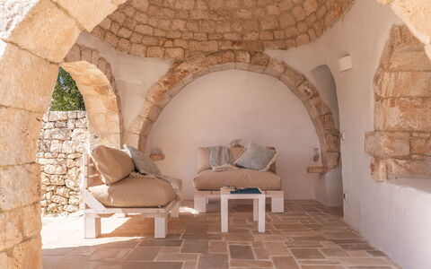 Masseria Le Monache: Wall, Furniture, Stone Wall, Brick, Natural Material, Chair, Living Room, Houseplant, Pillow