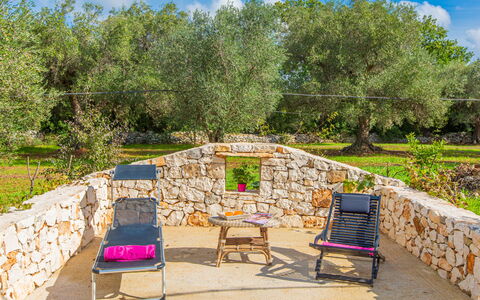 Trullo Della Quercia: Garden, Outdoor Furniture, Backyard, Shade, Landscaping, Stone Wall, Chair, Yard, Lawn, Park