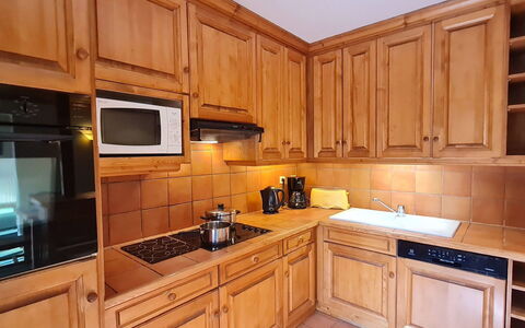 Alpina Lodge: Kitchen, Cabinetry, Kitchen Appliance, Countertop, Wood, Major Appliance, Flooring, Interior Design, Furniture, Cupboard