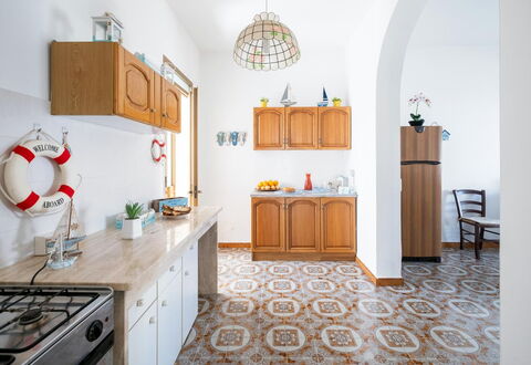 Villa Heart Island Vista Mare: Flooring, Floor, Interior Design, Furniture, Kitchen, Countertop, Cabinetry, Room, Tile, Wood Stain