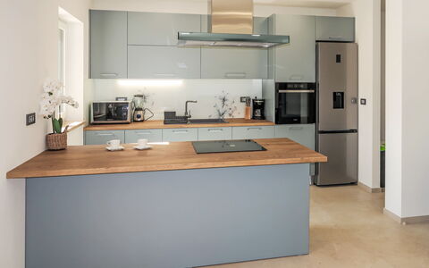 Villa Temelia: Kitchen, Countertop, Furniture, Kitchen Appliance, Cabinetry, Interior Design, Flooring, Major Appliance, Wood, Kitchen Stove