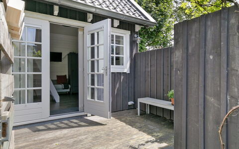 Residence Domburg: Wood, Door, Home, Siding, Cottage, Composite Material, Porch, Hardwood, Outdoor Furniture, Deck
