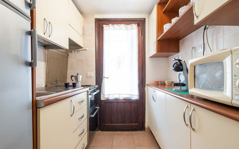 Casa ai Mandorli: Wood, Kitchen, Major Appliance, Flooring, Countertop, Kitchen Appliance, Cabinetry, Interior Design, Furniture, Floor