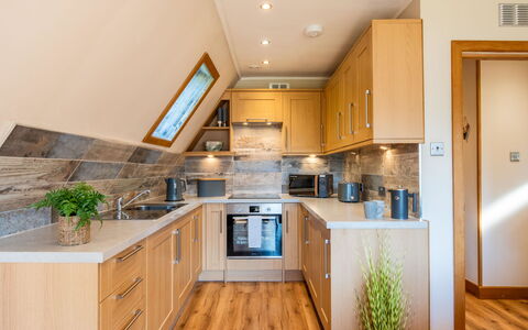 Sandpiper Lodge: Kitchen, Furniture, Interior Design, Flooring, Countertop, Wood, Kitchen Appliance, Floor, Cabinetry, Ceiling