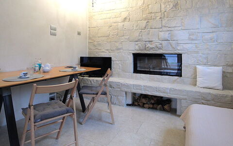 Design Loft, Romantic Retreat, Feltre: Wall, Furniture, Flooring, Interior Design, Floor, Stone Wall, Ceiling, Room, Living Room, Chair