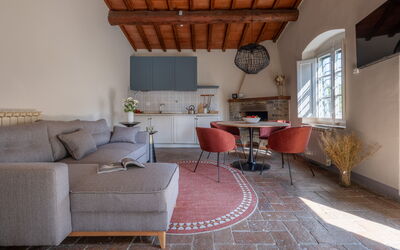 Relais Badia a Passignano - Appartamento Garnacha: Furniture, Wall, Flooring, Interior Design, Wood, Couch, Floor, Living Room, Chair, Table