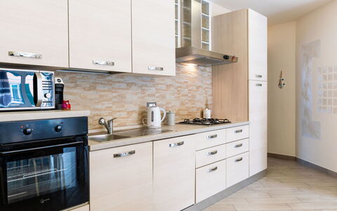 La Dimora del Pontile: Kitchen, Cabinetry, Countertop, Kitchen Appliance, Major Appliance, Wood, Furniture, Interior Design, Flooring, Cupboard