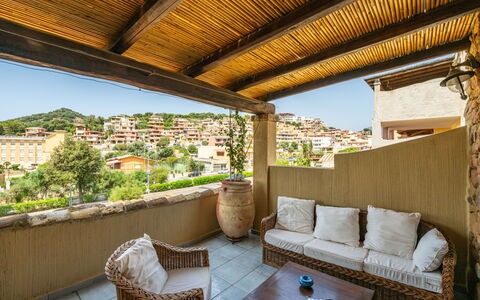 Golf Apartment: Furniture, Chair, Outdoor Furniture, Table, Outdoor Table, Kitchen & Dining Room Table, Umbrella, Shade, Restaurant, Patio