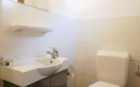 Casa Calanca: Bathroom, Bathroom Sink, Plumbing Fixture, Toilet Seat, Sink, Wall, Toilet, Interior Design, Flooring, Tap