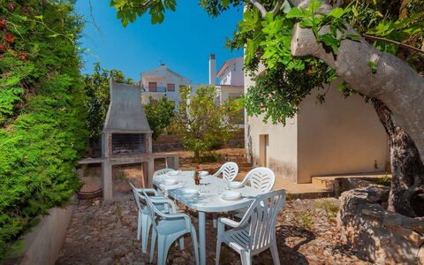 Tres Olivos: Plant, Table, Furniture, Building, Window, Chair, Sky, Outdoor Table, Outdoor Furniture, Wood