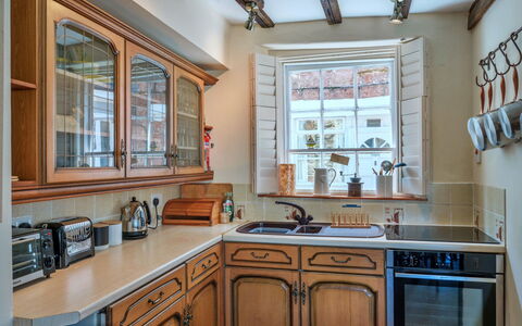 April Cottage: Kitchen, Countertop, Cabinetry, Wood, Interior Design, Kitchen Appliance, Furniture, Kitchen Sink, Lighting, Flooring
