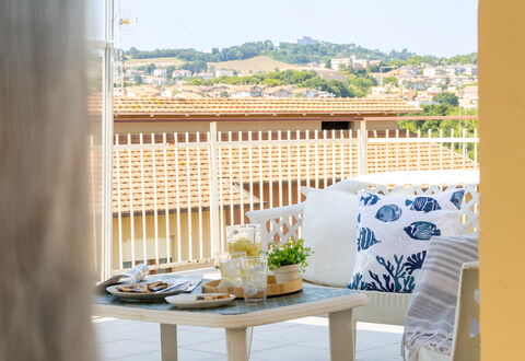 Sopraloreto Apartment: Furniture, Interior Design, Chair, Outdoor Furniture, Balcony, Shade, Wood Stain, Design, Houseplant, Linens