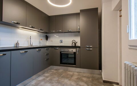 Piazza del Carmine Apartament: Kitchen, Countertop, Kitchen Appliance, Cabinetry, Interior Design, Major Appliance, Ceiling, Light Fixture, Flooring, Kitchen Stove