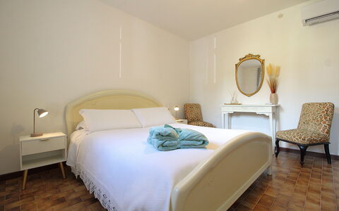 Villa Rosa Apartment: Bed, Furniture, Interior Design, Bedroom, Bedding, Bed Sheet, Wall, Floor, Wood, Flooring