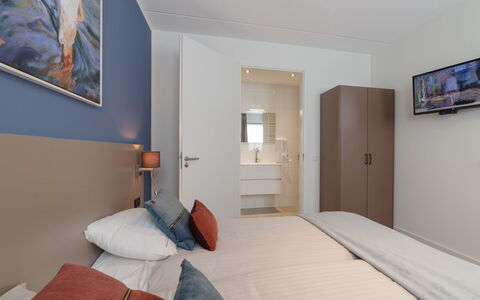 Ganuenta: Interior Design, Floor, Flooring, Furniture, Room, Ceiling, Bedroom, Bed, Bed Sheet, Picture Frame
