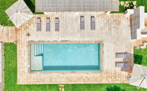 Trulli di Luccio: Swimming Pool, Composite Material, Flagstone, Outdoor Furniture, Resort, Water Feature, Garden, Shade, Landscaping, Estate