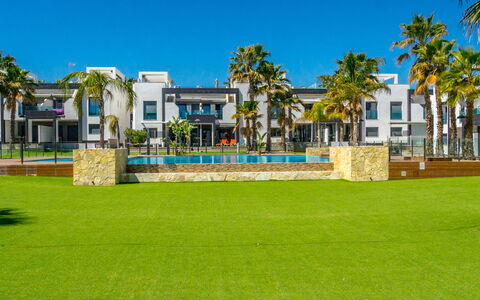 Oasis Beach 1: Roof, Shrub, House, Home, Cottage, Land Lot, Groundcover, Garden, Estate
