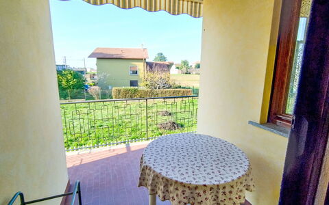 Green Haven: Balcony, Porch, Shade, Wood Stain, Handrail, Chair, Villa, Houseplant, Baluster, Backyard