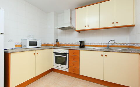 Castillo Playa: Room, Property, Kitchen, Furniture, Cabinetry, Building, Yellow, House, Real Estate, Kitchen Stove