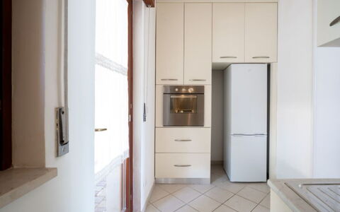 Villa Vitalis: Flooring, Countertop, Wood, Cabinetry, Floor, Interior Design, Kitchen, Kitchen Appliance, Major Appliance, Home