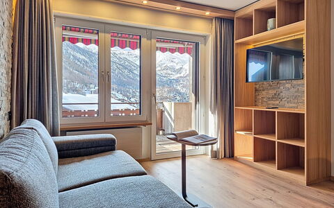 Zermatt 310: Interior Design, Room, Apartment, Living Room, Curtain, Wood Stain, Television, Glacial Landform, Chair, Hardwood