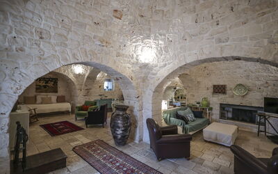 Trullo Suite: Wall, Furniture, Flooring, Ceiling, Interior Design, Floor, Lighting, Couch, Room, Living Room
