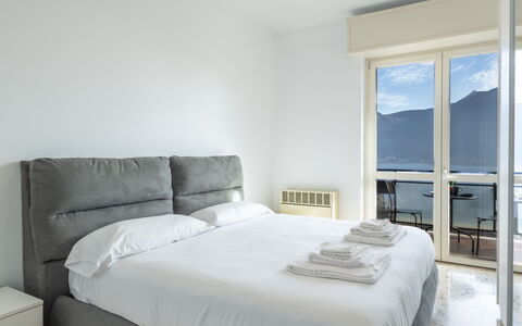 Lovere Balcony View: Bed, Furniture, Bedroom, Interior Design, Bedding, Bed Sheet, Room, Floor, Linens, Bed Frame