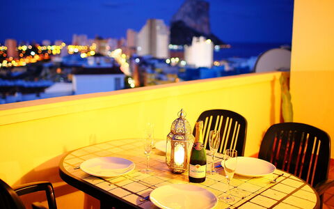 Calpe Calp 390: Table, Furniture, Property, Sky, Tableware, Chair, Light, Building, Water, Lighting