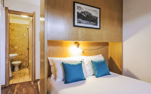 Fondue: Interior Design, Bed, Bedroom, Bed Sheet, Flooring, Floor, Bedding, Ceiling, Throw Pillow, Bed Frame