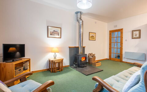 Old Stable on Aigas Golf Course: Furniture, Flooring, Interior Design, Floor, Ceiling, Room, Lighting, Living Room, Television, Couch